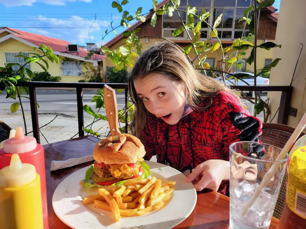 A Beautiful Hike, a Cemetery, and a Flower Festival… - Faith and her Boquete Burger at the Boquete Sandwich Shop
