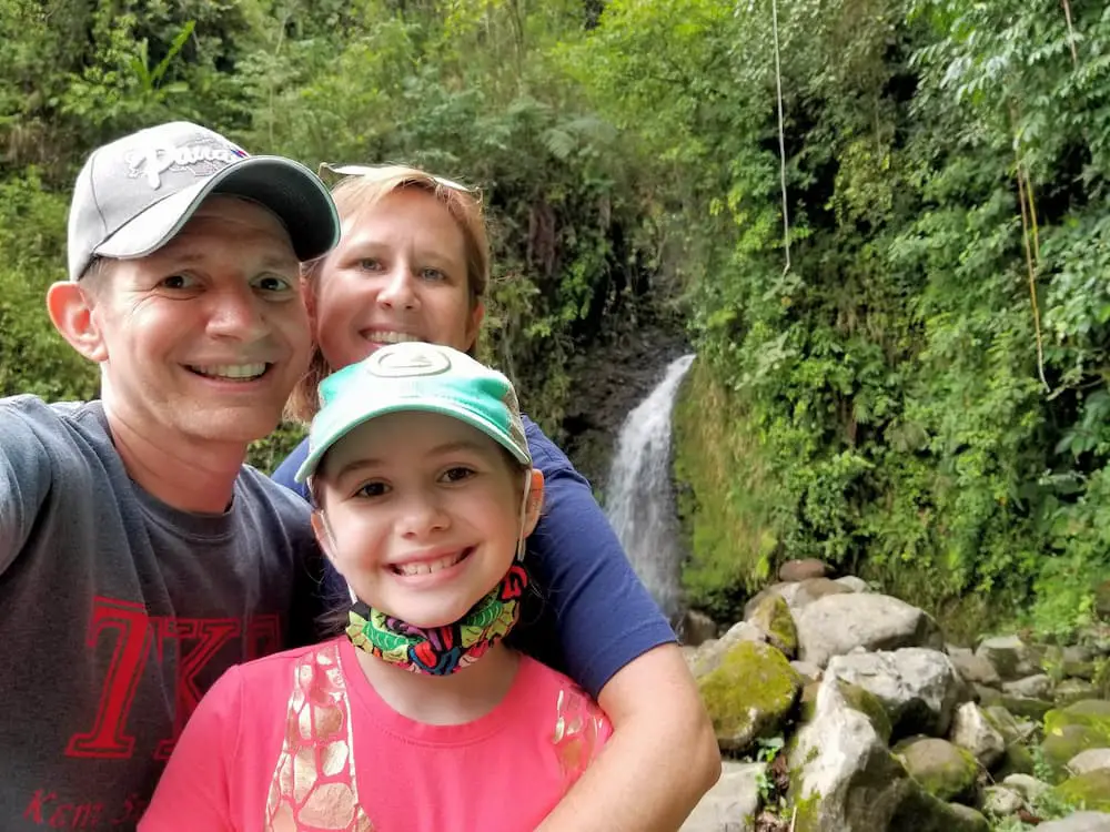 Designing Our New Life – The Power of Early Retirement - Jim, Lisa, and Faith in front of a waterfall