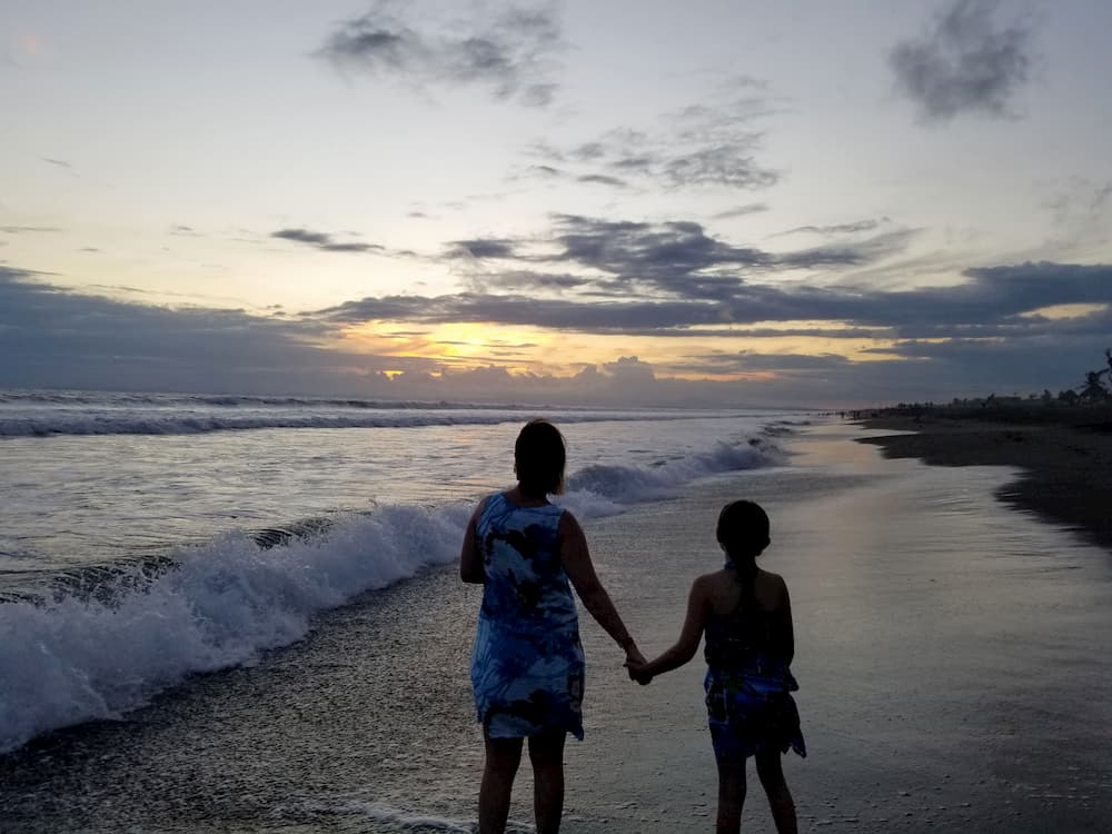 A Beach Vacation Totaling 5? Yes, Please! - Lisa and Faith on the Beach at Sunset