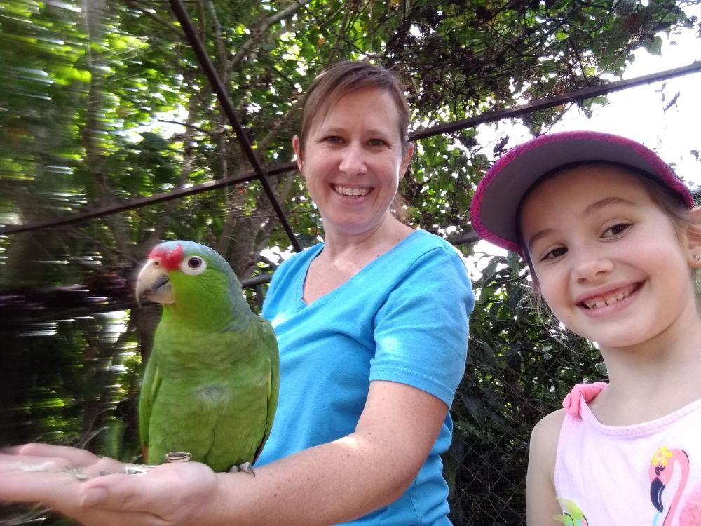 Lisa and Faith with a parrot