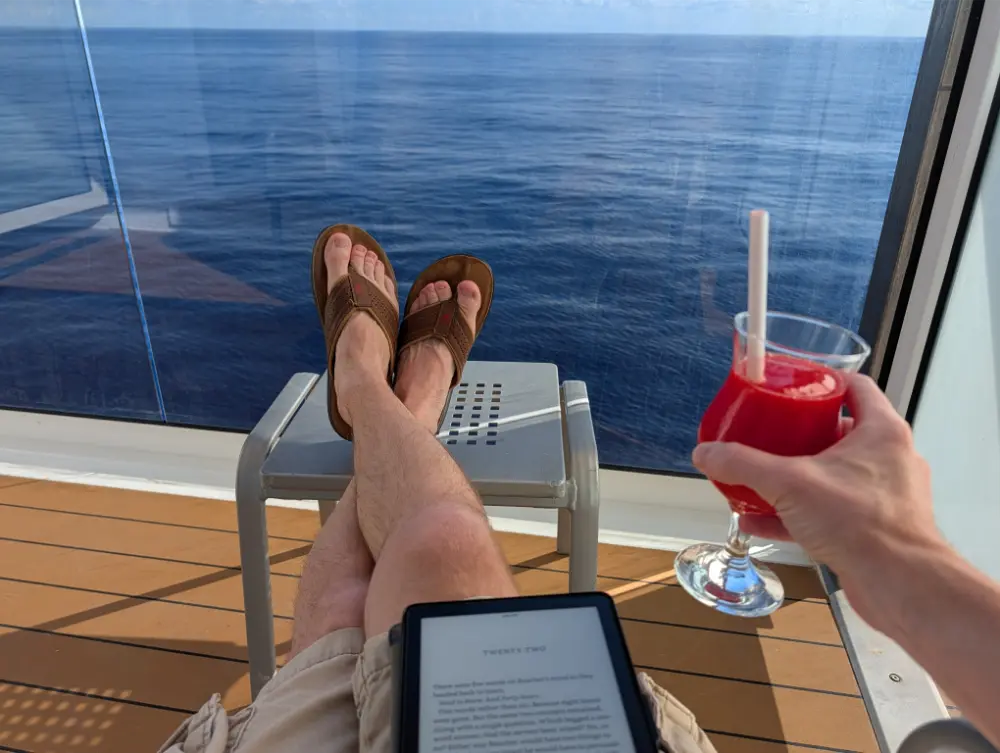 38-Day Europe Trip - Carnival Miracle - Reading on the balcony with a strawberry daiquiri
