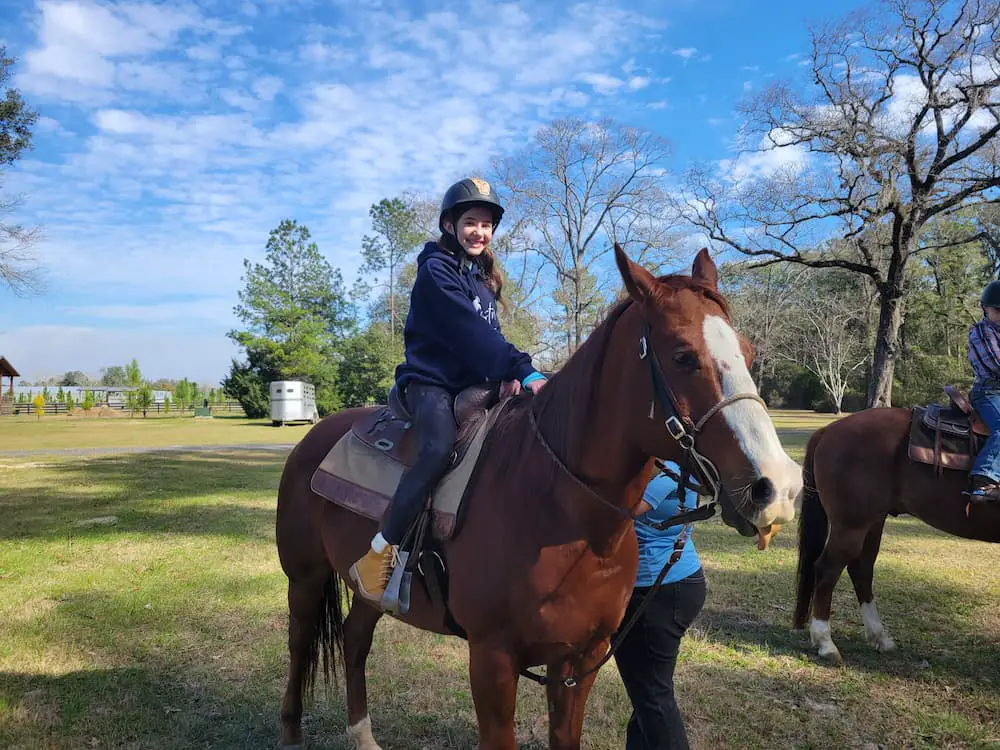 Our RV Trip Was Quickly Becoming a Florida Flop… Until We Shifted Gears - The Ranch at Trader Hill - Faith riding a horse